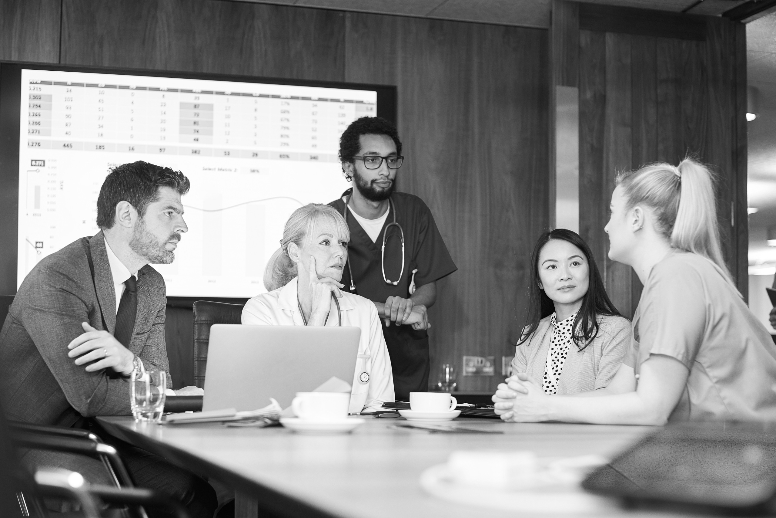 Healthcare team and administrators collaborating over data